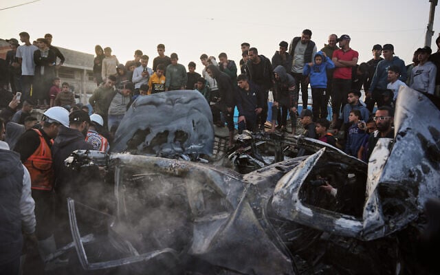 Palestinians inspect a vehicle struck by an Israeli airstrike in the Maghazi refugee camp in the central Gaza Strip, April 4, 2026. (Kareem Hana/AP) Palestinians inspect a vehicle struck by an Israeli airstrike in the Maghazi refugee camp in the central Gaza Strip, April 4, 2026. (Kareem Hana/AP)