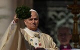 Pope Leo XIV sprinkles holy water with a bunch of hyssop sprigs as he presides over Easter Mass in St. Peter’s Square at the Vatican, April 5, 2026. (AP Photo/Andrew Medichini)