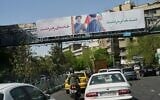 Cars drive under a billboard depicting the late Iranian supreme leader ayatollah Ali Khamenei handing an Iranian flag to his son Mojtaba Khamenei in Tehran, Iran, April 5, 2026. (AP Photo/Francisco Seco)