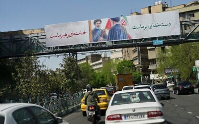 Cars drive under a billboard depicting the late Iranian supreme leader ayatollah Ali Khamenei handing an Iranian flag to his son Mojtaba Khamenei in Tehran, Iran, April 5, 2026. (AP Photo/Francisco Seco) Cars drive under a billboard depicting the late Iranian supreme leader ayatollah Ali Khamenei handing an Iranian flag to his son Mojtaba Khamenei in Tehran, Iran, April 5, 2026. (AP Photo/Francisco Seco)