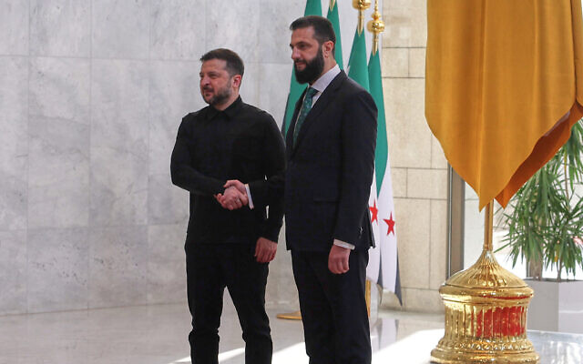 Syrian President Ahmad al-Sharaa, right, shakes hands with Ukrainian President Volodymyr Zelensky before a meeting at the People's Palace in Damascus, Syria, April 5, 2026. (AP Photo/Ghaith Alsayed) Syrian President Ahmad al-Sharaa, right, shakes hands with Ukrainian President Volodymyr Zelensky before a meeting at the People's Palace in Damascus, Syria, April 5, 2026. (AP Photo/Ghaith Alsayed)