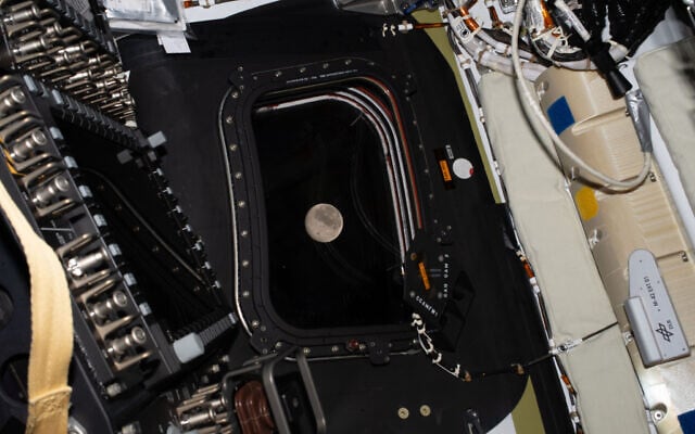 The moon, as seen in the window of the Orion spacecraft, at the end of day 5 of the journey to the moon, on April 6, 2026. (Artemis II crew, via NASA via AP)