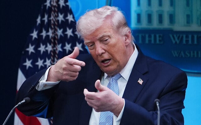 US President Donald Trump pretends to aim a sniper gun while speaking with reporters in the James Brady Press Briefing Room at the White House, April 6, 2026, in Washington. (AP/Julia Demaree Nikhinson)