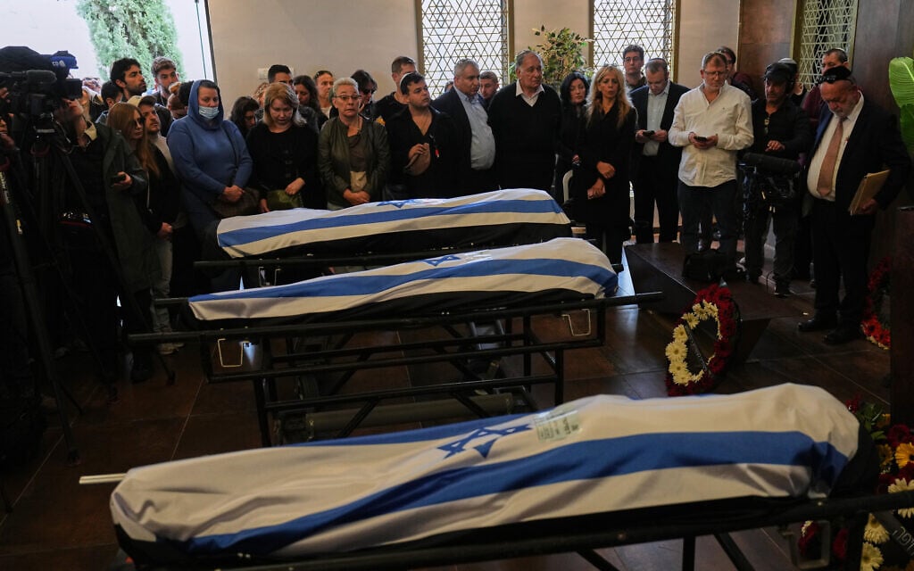 Mourners attend the funeral of three members of the Gershovich family who were killed when an Iranian missile struck their building, in Haifa, April 7, 2026. (AP Photo/Ariel Schalit)