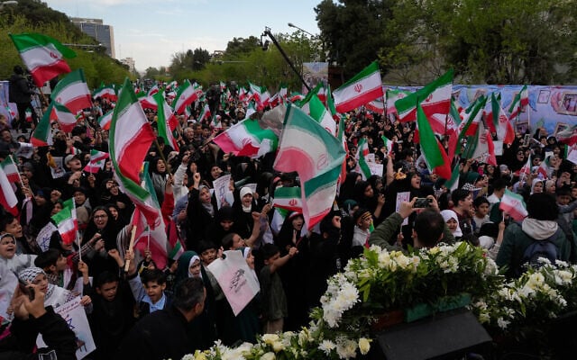 People wave Iranian flags and chant slogans in a memorial for school children who were killed during a strike on a school in southern town of Minab on February 28, in downtown Tehran, Iran, April 7, 2026. (AP Photo/Vahid Salemi) People wave Iranian flags and chant slogans in a memorial for school children who were killed during a strike on a school in southern town of Minab on February 28, in downtown Tehran, Iran, April 7, 2026. (AP Photo/Vahid Salemi)