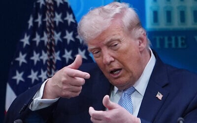 US President Donald Trump pretends to aim a sniper gun while speaking with reporters in the James Brady Press Briefing Room at the White House, in Washington, April 6, 2026. (AP Photo/Julia Demaree Nikhinson, File)