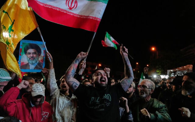 Pro-government demonstrators chant slogans as they hold Iranian flags and a poster of the Supreme Leader Ayatollah Mojtaba Khamenei in a gathering after announcement of a two-week ceasefire in the war with the United States and Israel, at the Enqelab-e-Eslami, or Islamic Revolution, Square, in Tehran, Iran, early on Wednesday, April 8, 2026. (AP Photo/Vahid Salemi) Pro-government demonstrators chant slogans as they hold Iranian flags and a poster of the Supreme Leader Ayatollah Mojtaba Khamenei in a gathering after announcement of a two-week ceasefire in the war with the United States and Israel, at the Enqelab-e-Eslami, or Islamic Revolution, Square, in Tehran, Iran, early on Wednesday, April 8, 2026. (AP Photo/Vahid Salemi)