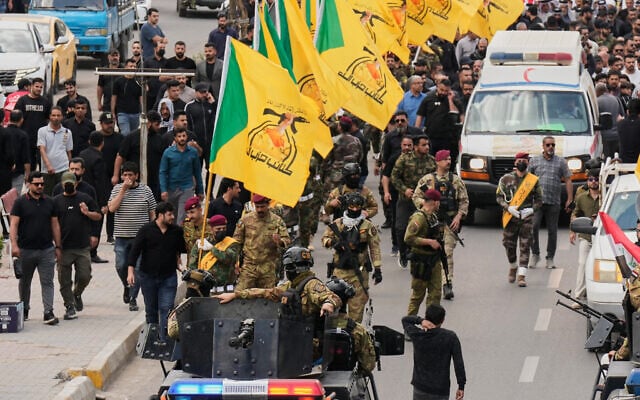 Members of an Iraqi Shiite militant group attend a funeral of a fighter with the Kataeb Hezbollah, who was killed in a US airstrike in Basra province south of Baghdad, Iraq, April 8, 2026. (AP Photo/Hadi Mizban)