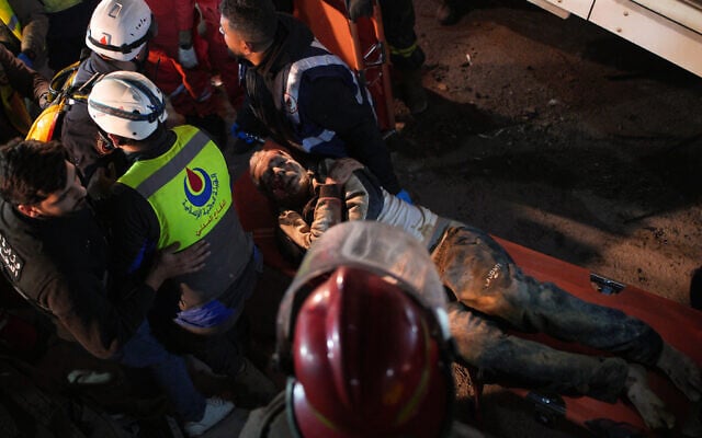 Rescuers carry an injured man from a destroyed building that was hit in an Israeli airstrike in central Beirut, Lebanon, Wednesday, April 8, 2026. (AP Photo/Emilio Morenatti)