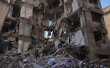 Lebanese civil defense workers search for casualties in the rubble of a building destroyed in an Israeli airstrike a day earlier in central Beirut, Lebanon, on April 9, 2026. (AP/Hassan Ammar)