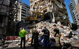 Lebanese civil defense workers and army soldiers work on the search for victims in the rubble at the site of a building destroyed in an Israeli airstrike a day earlier in central Beirut, Lebanon, April 9, 2026. (AP Photo/Hussein Malla)