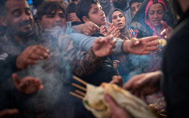 Displaced families extend their hands while waiting for donated food beside the tents they use as shelters after fleeing Israeli bombardment in southern Lebanon, in Beirut, Lebanon, April 9, 2026. (AP Photo/Emilio Morenatti) Displaced families extend their hands while waiting for donated food beside the tents they use as shelters after fleeing Israeli bombardment in southern Lebanon, in Beirut, Lebanon, April 9, 2026. (AP Photo/Emilio Morenatti)