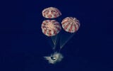 In this image from video provided by NASA, the Artemis II Orion capsule splashes down in the Pacific Ocean, on Friday, April 10, 2026. (NASA via AP)