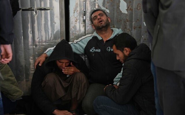 Palestinians mourn over the bodies of men killed in an Israeli strike in al-Bureij refugee camp, before their funeral at Al-Aqsa Hospital in Deir al-Balah, central Gaza Strip, April 11, 2026. (AP Photo/Abdel Kareem Hana)