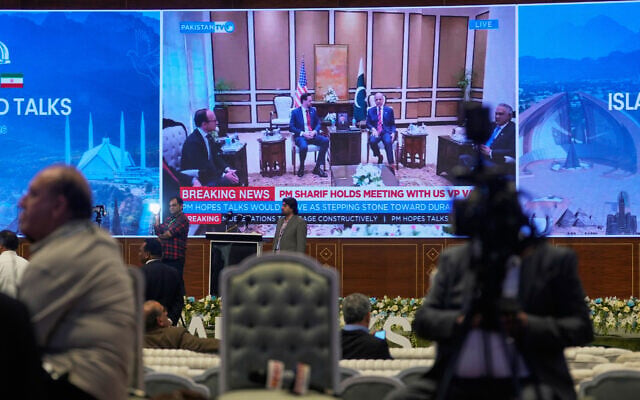Journalists work as Pakistan's state run television telecasts US Vice President JD Vance meeting with Pakistani Prime Minister Shehbaz Sharif at a media center setup for the coverage of US-Iran talks in Islamabad, Pakistan, April 11, 2026. (AP Photo/Anjum Naveed)