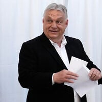 Hungary's Prime Minister Viktor Orban prepares to cast his ballot at a polling station in Budapest, Hungary, April 12, 2026. (AP Photo/Petr David Josek)