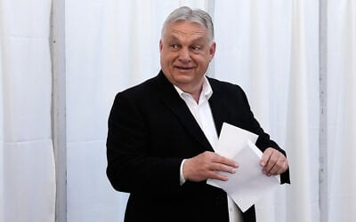 Hungary's Prime Minister Viktor Orban prepares to cast his ballot at a polling station in Budapest, Hungary, April 12, 2026. (AP Photo/Petr David Josek)