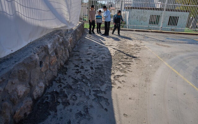Children look at a damaged play ground hit the day before by projectiles launched from Lebanon in Nahariya, northern Israel, April 12, 2026. (AP Photo/Ariel Schalit) Children look at a damaged play ground hit the day before by projectiles launched from Lebanon in Nahariya, northern Israel, April 12, 2026. (AP Photo/Ariel Schalit)