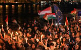 Supporters of Peter Magyar, the leader of the opposition Tisza party celebrate after a parliamentary election in Budapest, Hungary, April 12, 2026. (AP Photo/Darko Bandic)