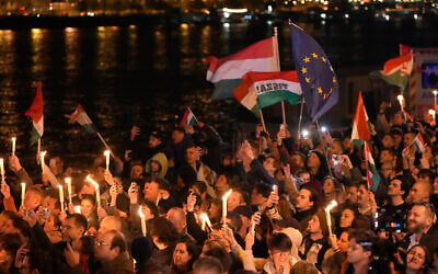 Supporters of Peter Magyar, the leader of the opposition Tisza party celebrate after a parliamentary election in Budapest, Hungary, April 12, 2026. (AP Photo/Darko Bandic)