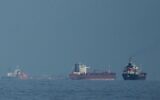 Oil tankers and cargo ships line up in the Strait of Hormuz as seen from Khor Fakkan, United Arab Emirates, March 11, 2026. (AP/Altaf Qadri,File)