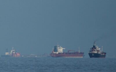 Oil tankers and cargo ships line up in the Strait of Hormuz as seen from Khor Fakkan, United Arab Emirates, March 11, 2026. (AP/Altaf Qadri,File)
