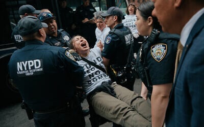 Protesters with Jewish Voice for Peace get arrested after blocking traffic during a demonstration outside the New York office of U.S. Sen. Chuck Schumer, calling for an end to the US-Israel war with Iran and opposing US weapons support on Monday, April 13, 2026, in New York. (AP Photo/Andres Kudacki)