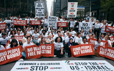 Protesters with the anti-Israel organization Jewish Voice for Peace block traffic during a demonstration outside the New York office of US Sen. Chuck Schumer, calling for an end to the US-Israel war with Iran and opposing US weapons support on Monday, April 13, 2026, in New York. (AP Photo/Andres Kudacki)