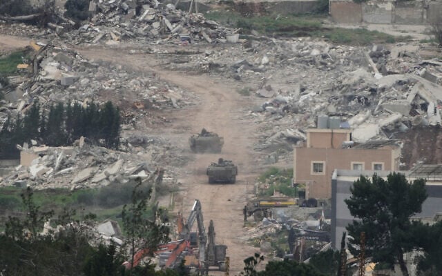 Israeli army vehicles and bulldozers operating in southern Lebanon, as seen from northern Israel, April 15, 2026. (AP Photo/Ariel Schalit)