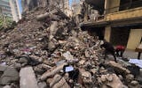 Workers search amongst the rubble of a destroyed building that was hit a week ago in an Israeli airstrike in central Beirut, Lebanon, April 16, 2026. (AP Photo/Hussein Malla)