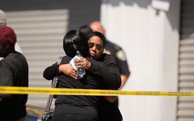 Council woman Tabatha Taylor (right) hugs an unknown person outside the scene of a mass shooting in Shreveport, Louisiana, April 19, 2026. (AP/Gerald Herbert)