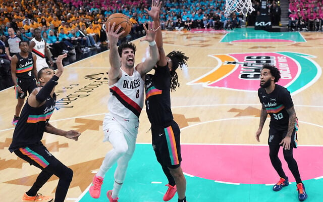 Portland Trail Blazers forward Deni Avdija (8) drives to the basket against San Antonio Spurs guard Stephon Castle (5) during the first half in Game 1 of a first-round NBA playoffs basketball series in San Antonio, April 19, 2026. (AP/Eric Gay)