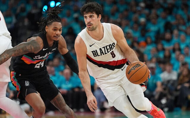 Portland Trail Blazers forward Deni Avdija (8) drives against San Antonio Spurs guard Devin Vassell (24) during the first half in Game 1 of a first-round NBA playoffs basketball series in San Antonio, April 19, 2026. (AP/Eric Gay)