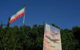 A banner shows a graphic depicting Iranian-built drones with a sign in Farsi that reads: "Arash drone is the nightmare for Iran's enemies," as an Iranian flag waves at left, in Tehran, Iran, April 21, 2026. (AP Photo/Vahid Salemi)