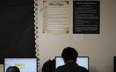US students work under Ten Commandments and Bill of Rights posters on display in a classroom at Lehman High School in Kyle, Texas on October 16, 2025. (AP Photo/Eric Gay, File)