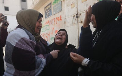 Palestinians mourn over people killed in an Israeli strike during their funeral at Al-Shifa Hospital in Gaza City, April 25, 2026. (AP Photo/Yousef Alzanoun)