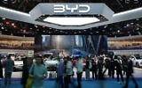 Visitors tour Chinese automaker BYD's booth with a screen showing its battery charging station under sub-zero temperatures, at the Auto China 2026 show in Beijing, April 25, 2026. (AP/Andy Wong)