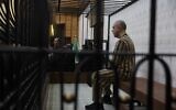 Atef Najib, former head of the Political Security Branch in the Daraa area during Bashar al-Assad's rule, sits in the defendants' cage during a trial session at the Palace of Justice in Damascus, Syria, April 26, 2026. (AP Photo/Ghaith Alsayed)