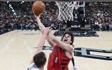 Portland Trail Blazers forward Deni Avdija (8) goes to the basket as San Antonio Spurs center/forward Luke Kornet defends during the first half in Game 5 of a first-round NBA playoffs basketball series in San Antonio, April 28, 2026. (AP Photo/Eric Gay)