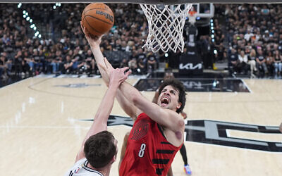 Portland Trail Blazers forward Deni Avdija (8) goes to the basket as San Antonio Spurs center/forward Luke Kornet defends during the first half in Game 5 of a first-round NBA playoffs basketball series in San Antonio, April 28, 2026. (AP Photo/Eric Gay)