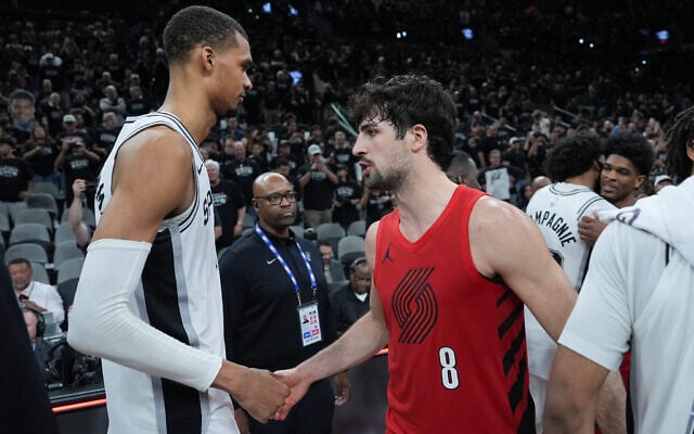 Portland Trail Blazers forward Deni Avdija (8) greets San Antonio Spurs forward/center Victor Wembanyama after Game 5 of a first-round NBA playoffs basketball series in San Antonio, April 28, 2026. (AP Photo/Eric Gay)