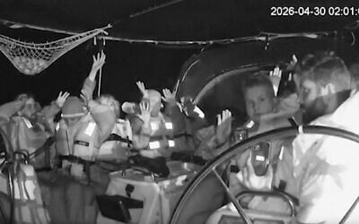 This grab from black and white CCTV footage shows members on flotilla boat with hands in air as Israeli forces intercepted activists who set sail earlier this month from Barcelona attempting to break Israel’s maritime blockade of Gaza, near the southern Greek island of Crete, April 30, 2026. (Global Sumud Flotilla via AP)