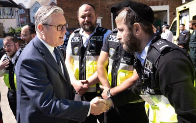 Britain's Prime Minister Keir Starmer (left) meets first responders from Shomrim North West London during a visit to Golders Green, northwest London, April 30, 2026, following a terror attack on April 29 in which two Jewish men were stabbed and seriously hurt. (Stefan Rousseau/Pool via AP) Britain's Prime Minister Keir Starmer (left) meets first responders from Shomrim North West London during a visit to Golders Green, northwest London, April 30, 2026, following a terror attack on April 29 in which two Jewish men were stabbed and seriously hurt. (Stefan Rousseau/Pool via AP)
