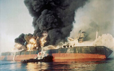 The Singapore-registered tanker Norman Atlantic sits ablaze in the Strait of Hormuz on December 6, 1987, after being attacked by an Iranian gunboat. (AP Photo)