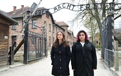 Catherine Szkop (left) and Abbie Talmoud, survivors of the terror attack at the Capital Jewish Museum in Washington, DC, stands at the gate to Auschwitz on April 13, 2026. (Yossi Zeliger)