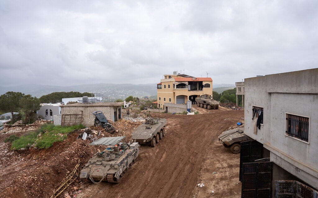 Israeli armored vehicles are seen in the southern Lebanon village of Ayta ash-Shab, April 19, 2026. (Emanuel Fabian/Times of Israel)