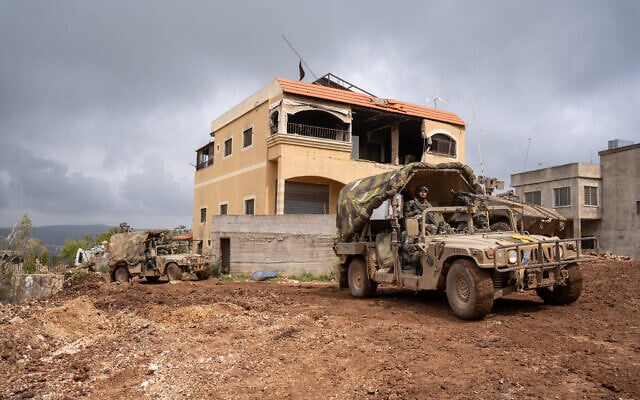 Israeli troops are seen riding in Humvees in the southern Lebanon village of Ayta ash-Shab, April 19, 2026. (Emanuel Fabian/Times of Israel)