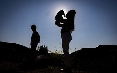 In a photo taken on February 21, 2024, Revital Shamir with her 4-year-old son Lavi and newborn girl Ori are at their home in Havat Yair (Yair's Farm). Revital's husband Mordechai was killed in military service while fighting Hamas terrorists at Kibbutz Re'im on October 7, 2023. (Chaim Goldberg/FLASH90)