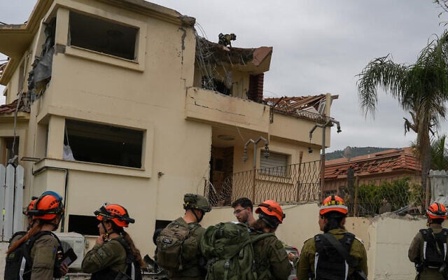Israeli security and rescue forces at the scene of damage caused by a missile attack from Lebanon in the northern city of Kiryat Shmona, April 1, 2026. (Ayal Margolin/Flash90) Israeli security and rescue forces at the scene of damage caused by a missile attack from Lebanon in the northern city of Kiryat Shmona, April 1, 2026. (Ayal Margolin/Flash90)