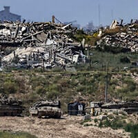 Illustrative: Israeli tanks stationed inside the Gaza Strip, as seen from southern Israel, April 10, 2026. (Tsafrir Abayov/Flash90)